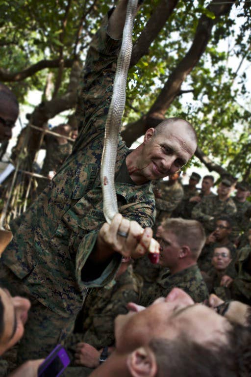 U.S. Marine Corps Staff Sgt. Kurt Bellmont, platoon sergeant, 3rd Platoon, Company A, 1st Battalion, 3rd Marine Regiment feeds cobra blood cobra blood to his Marines, which can be a useful source of energy , to his Marines during a jungle survival course in Ban Chan Krem, Chanthaburi province, Kingdom of Thailand, Feb. 17. The class was held to teach U.S. Marines basic jungle survival techniques as part of Exercise Cobra Gold 2013 (CG13). CG 13, in its 32nd iteration, is designed to advance regional security and ensure effective response to regional crises by exercising a robust multinational force from nations sharing common goals and security commitments in the Asia-Pacific region. (U.S. Marine Corps photo by Sgt. Matthew Troyer/Released)
