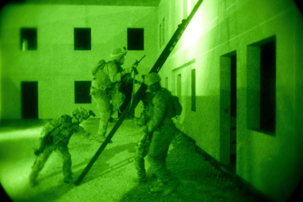 U.S. Marines and British airmen with 51st Squadron, Royal Air Force Regiment, search a building for threats as part of Exercise Eager Lion at the King Abdullah Special Operations Training Center in Amman, Jordan, May 15, 2015. (U.S. Marine Corps photo by Cpl. Sean Searfus)