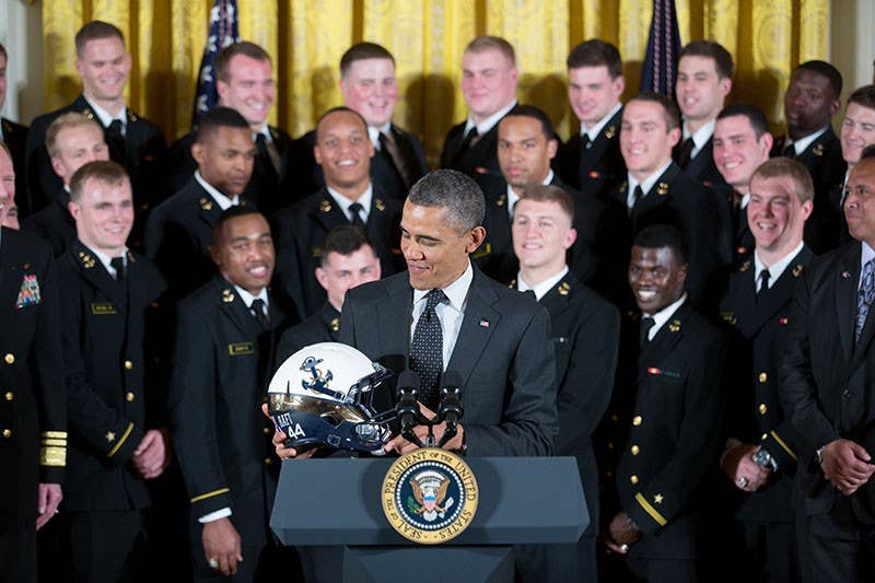 President Barack Obama looks at the helmet given to him by the United States Naval Academy football team during the ceremony to present the Commander-in-Chief Trophy to the team in the East Room of the White House, April 12, 2013. (Official White House Photo by Chuck Kennedy)