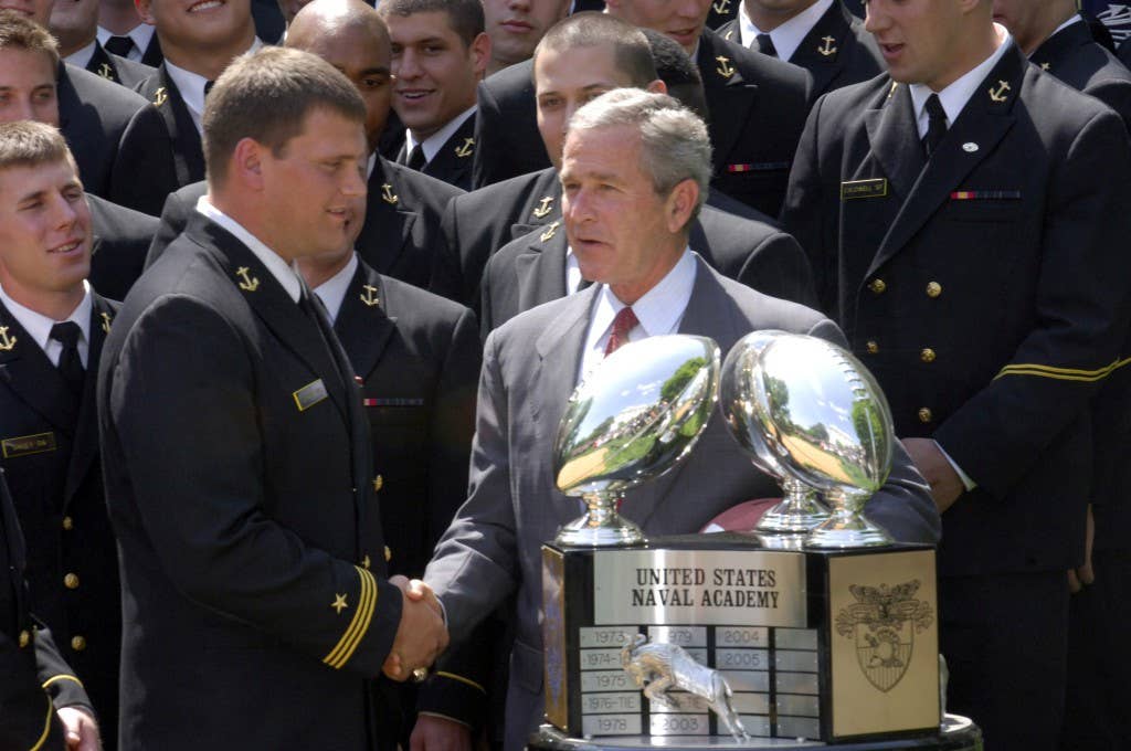 President George W. Bush congratulates the Navy football team during the Commander In Chief's trophy ceremony at the White House Rose Garden. (U.S. Navy photo by Chief Journalist Alan J. Baribeau)