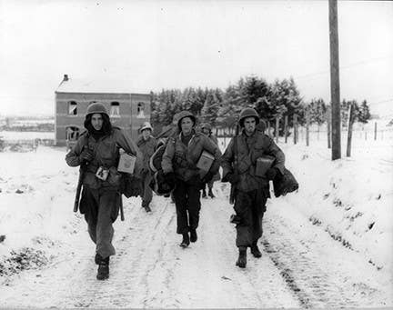 101st Airborne Division paratroopers Pfc. M.L. Dickens of East Omaha, Nebraska, Pvt. Sunny Sundquist of Bremerton, Washington, and Sgt. Francis H. McCann of Middleton, Conn., set out to rejoin their unit near Bastogne on Jan. 11, 1945.