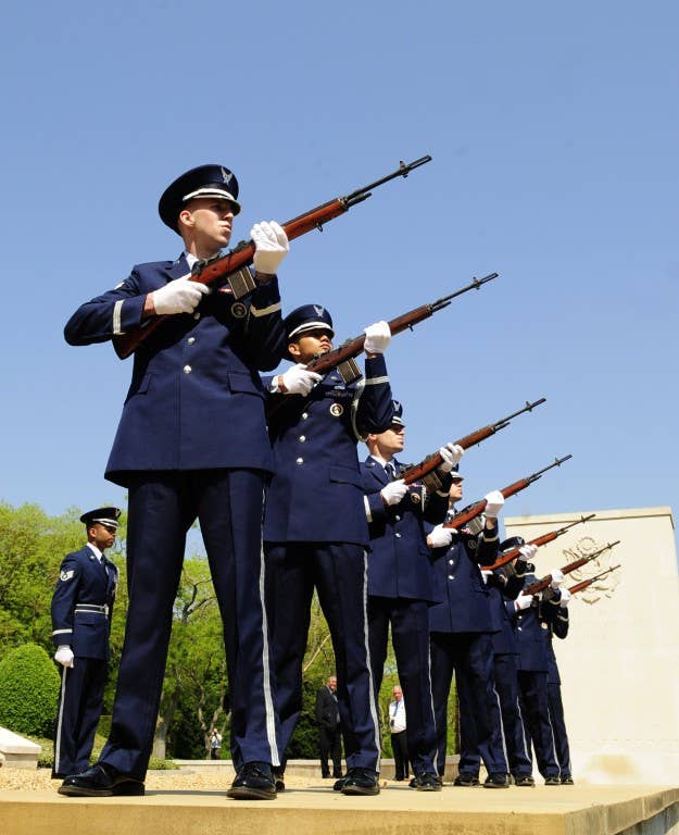 The RAF Mildenhall Honor Guard performs a three-volley salute during the Madingley American Cemetery Memorial Service in Cambridge. (U.S. Air Force Photo)