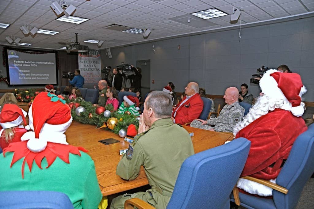 Santa visited Peterson AFB for his NORAD mission brief in preparation for Christmas Eve Dec. 16. People can find out where Santa is Dec. 24 all day by calling NORAD at 1-877-Hi-NORAD or by visiting www.noradsanta.org. (Photo by: MC2 (AW) Bansil, Jhomil,) NORADSanta