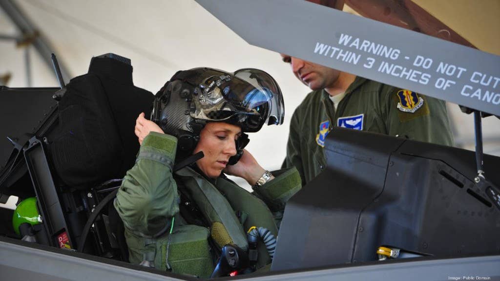 Lt. Col. Christine Mau, 33rd Operations Group puts on her helmet before taking her first flight in the F-35A at Eglin Air Force Base, Florida. (U.S. Air Force photo by Staff Sgt. Marleah Robertson)