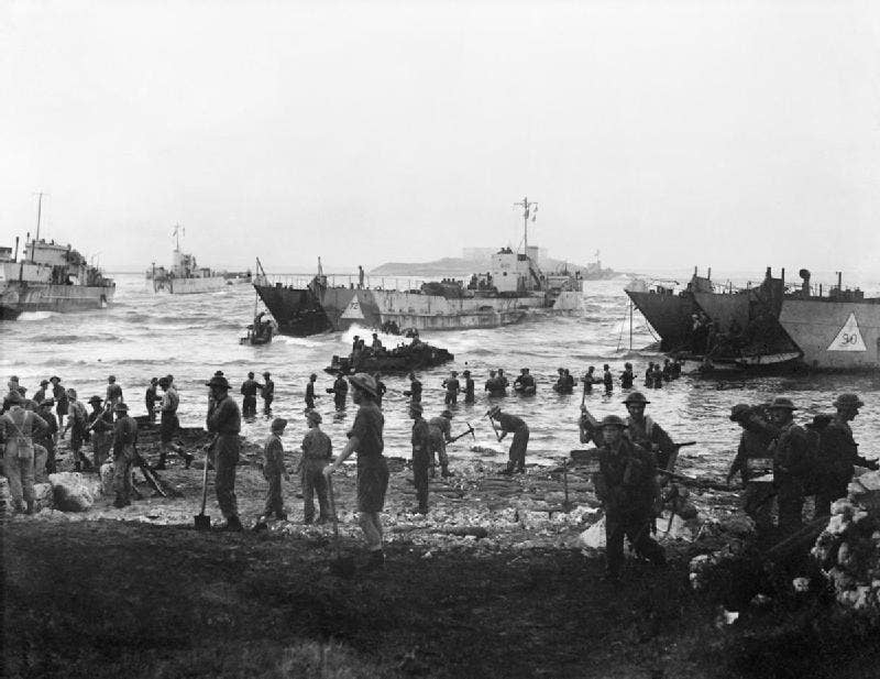 Troops and equipment come ashore on the first day of the invasion of Sicily. Photo: Royal Navy C. H. Parnall