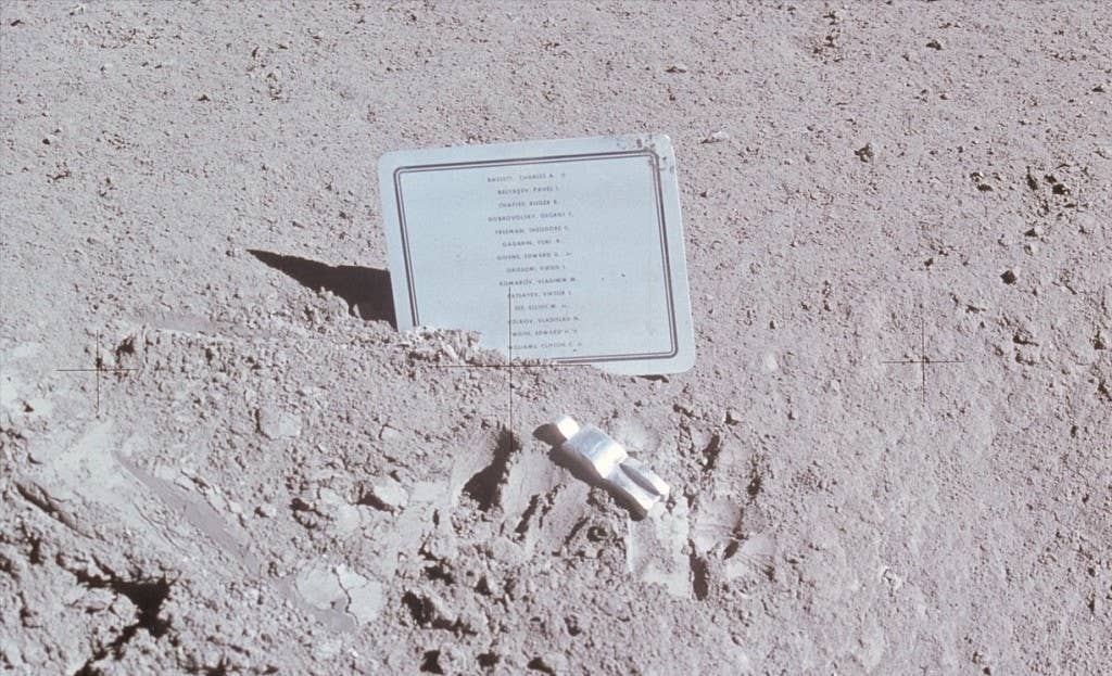 A close-up view of a commemorative plaque left on the Moon at the Hadley-Apennine landing site in memory of 14 NASA astronauts and USSR cosmonauts. (NASA Photo)
