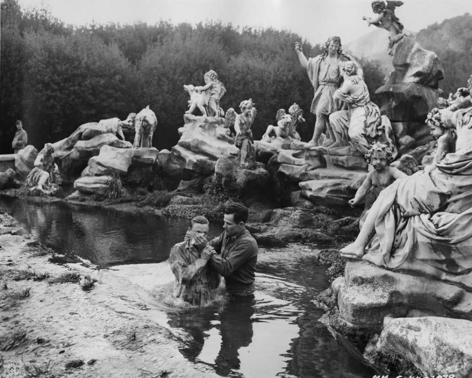 A US Army soldier is baptized by a chaplain in the fountain at the Palace of Caserta. Photo: US Army
