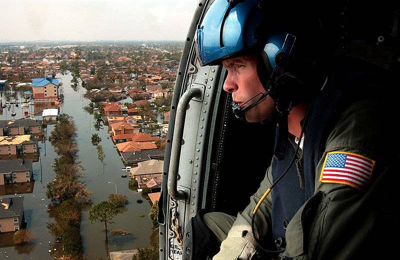 U.S. Coast Guard Petty Officer 2nd Class Shawn Beaty of Long Island, N.Y., looks for survivors in the path of Hurricane Katrina as he flies in an HH-60J Jayhawk helicopter over New Orleans. (U.S. Coast Guard photo by Petty Officer 2nd Class NyxoLyno Cangemi)