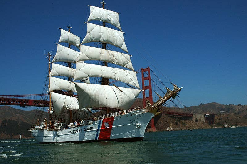 The Coast Guard Cutter Eagle sails under the Golden Gate Bridge during the Festival of Sail on San Francisco Bay. The Eagle is a three-masted barque that carries square-rigged sails on the fore and main masts. (Coast Guard photo by Petty Officer Sherri Eng)