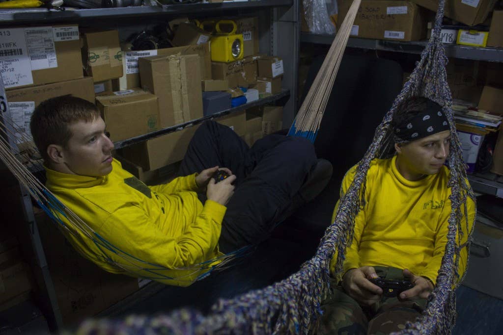 Sailors play video games in a supply office after flight operations on the amphibious assault ship USS Boxer (LHD 4). (U.S. Navy photo by Aviation Boatswain's Mate (Handling) Joni Bills)