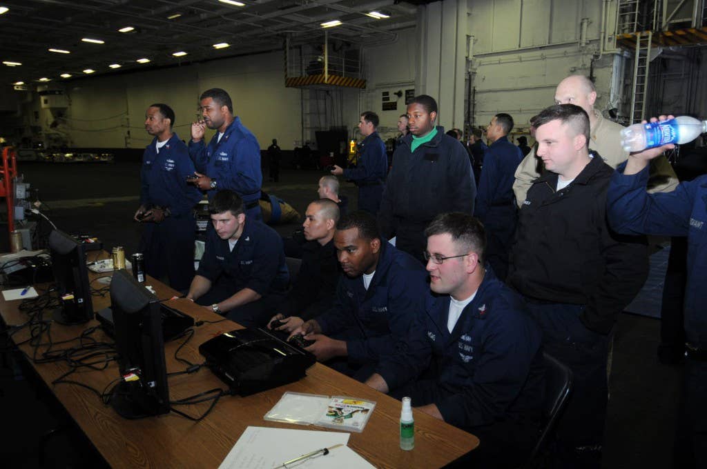 Nimitz Sailors participate in a video game tournament during Morale, Welfare and Recreation (MWR) events in the hangar bay of the nuclear-powered aircraft carrier USS Nimitz (CVN 68). (U.S. Navy photo by Mass Communication Specialist 3rd Class Mark Sashegyi)