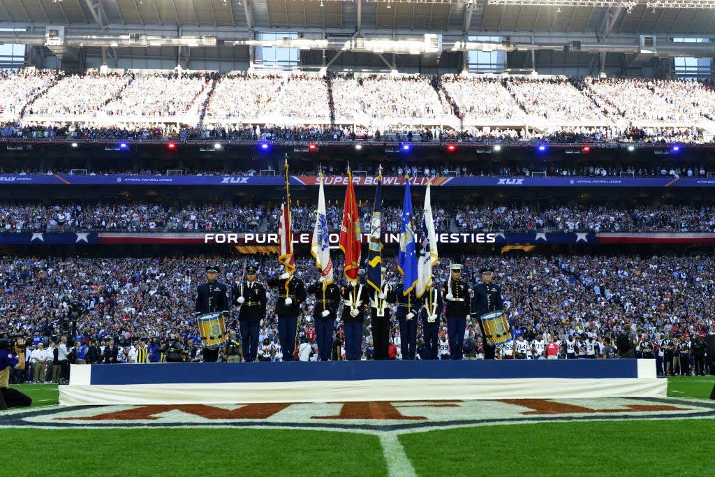 Members of the Joint Armed Forces Color Guard perform during opening ceremonies for the Super Bowl XLIX at the University of Phoenix Stadium, Feb. 1, 2015. Entertainer Idina Menzel sang the national anthem. (U.S. Air Force photo by Staff Sgt. Staci Miller)