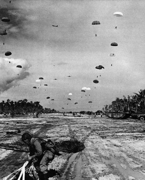 A large scale combat jump with several paratroopers in parachutes