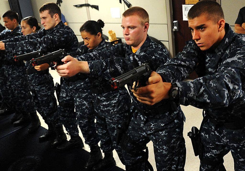 These Navy recruits put on their serious faces while snapping in.