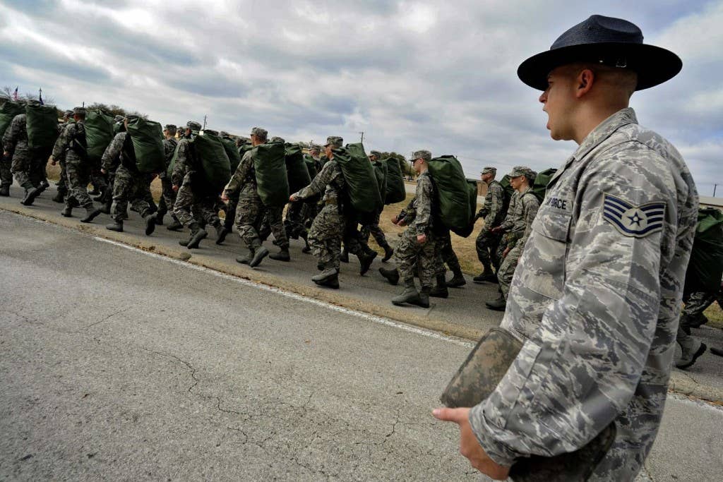 Staff Sgt. Robert George, a military training instructor at Lackland Air Force Base, Texas, marches his unit following the issuance of uniforms and gear. (U.S. Air Force photo/Master Sgt. Cecilio Ricardo)