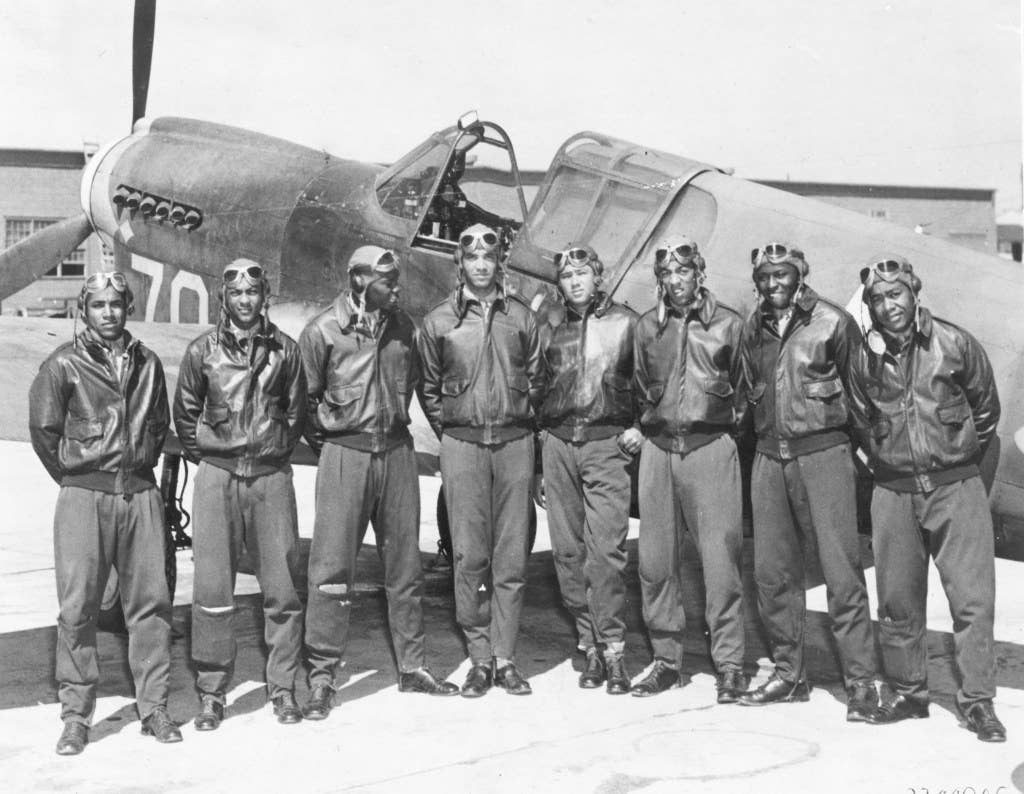 Eight Tuskegee Airmen in front of a P-40 fighter aircraft | U.S. Air Force photo