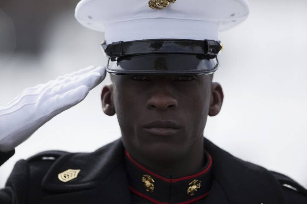 A Marine salutes the American flag during a wreath laying ceremony at the Marine Corps War Memorial in Washington. The ceremony commemorated the 70th anniversary of the battle for Iwo Jima. With most of the surviving veterans in their 80's and 90's, surviving Marines visited the memorial in remembrance of their brothers in arms. | Photo by U.S. Marine Corps