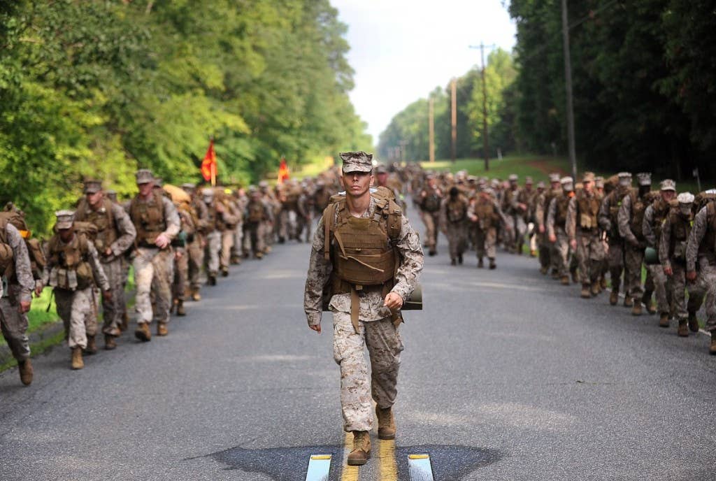 A Marine supervises from the center of The Basic School permanent personnel battalion during a 10-mile hike aboard the westside of Marine Corps Base Quantico, Va., June 28, 2013. | Photo by Lance Cpl. Cuong Le, U.S. Marine Corps
