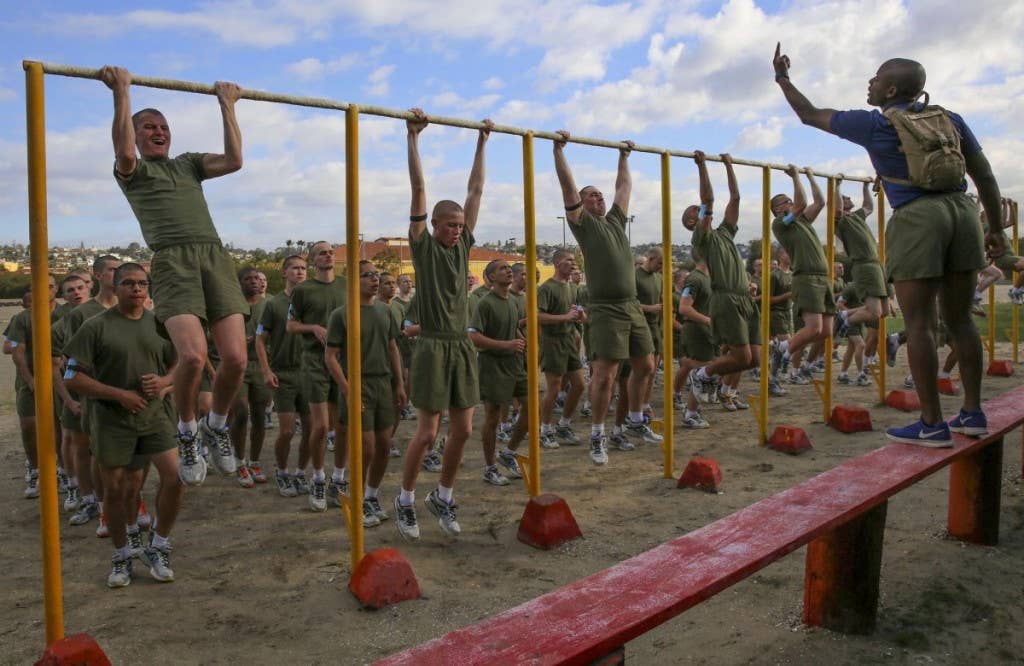 Recruits of India Company, 3rd Recruit Training Battalion, conduct pull-ups during a physical training event at Marine Corps Recruit Depot San Diego, Dec. 28. During the event, drill instructors motivated each recruit to try their best while conducting each set of exercises. Annually, more than 17,000 males recruited from the Western Recruiting Region are trained at MCRD San Diego. | Photo by Lance Cpl. Angelica I. Annastas, U.S. Marine Corps