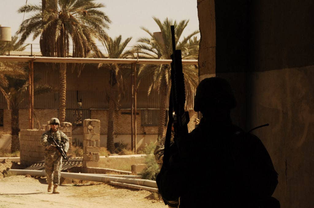 A U.S. Marine with Civil Affairs Task Force 1-77 provides security at the glass factory in the city of Ar Ramadi, Iraq (U.S. Marine Corps photo)