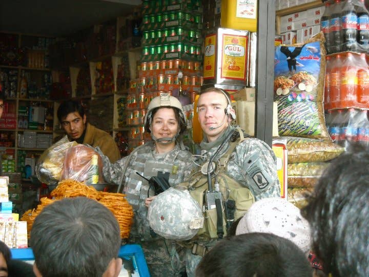 Henry Hughes and his interpreter purchase items from a stall in Afghanistan during a deployment. (Photo courtesy Henry Hughes)
