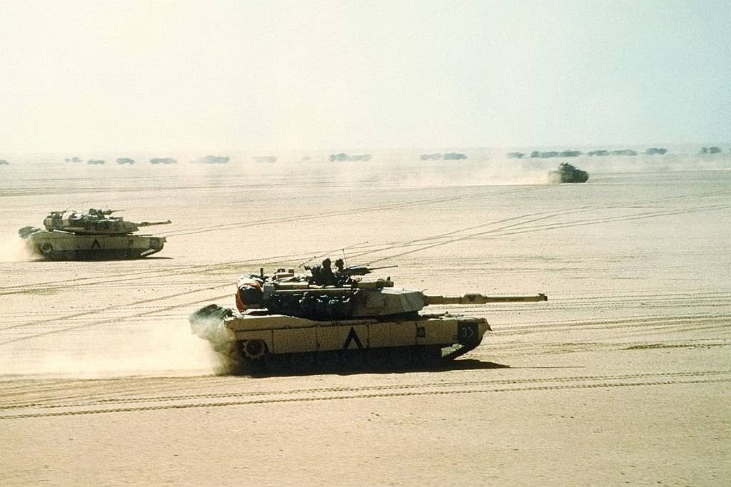 Abrams tanks and a Bradley Infantry Fighting Vehicle move out during Operation Desert Storm. (Photo: U.S. Navy D. W. Holmes II)