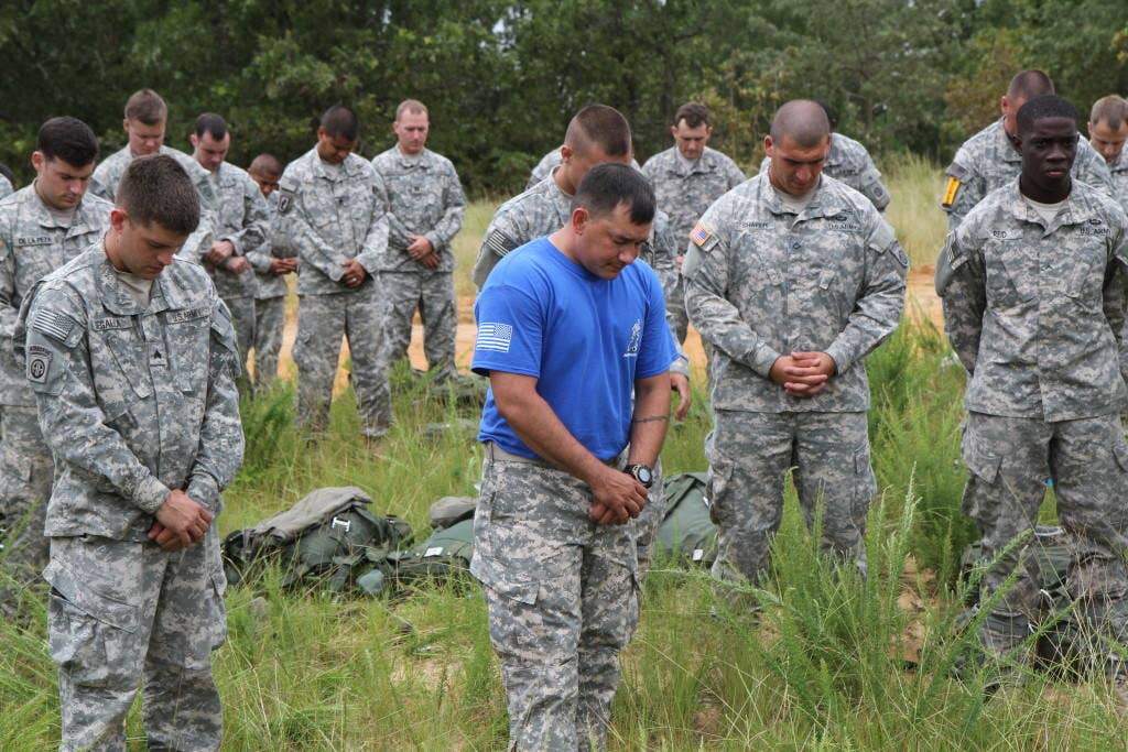 U.S. Army paratroopers with the 82nd Airborne Division, pray before the Chaplain's Anniversary Jump onto Sicily Drop Zoneat Fort Bragg, N.C., July 25, 2013. Deputy Chief of Chaplains, Brig. Gen. Charles R. Bailey led the prayer. Fort Bragg Chaplains celebrated the 238th anniversary of the Chaplains Corps with an airborne operation. (U.S. Army photo by Sgt. Brian P. Glass/Released)