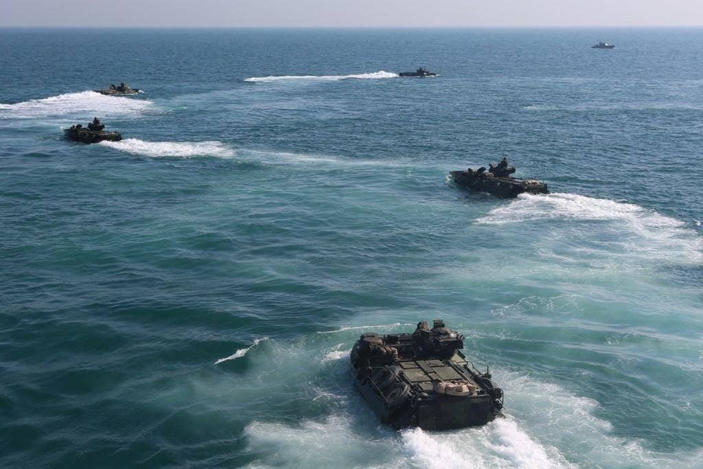 Assault amphibious vehicles (AAVs) with the AAV platoon, Echo Company, Battalion Landing Team 2nd Battalion, 1st Marines, 11th Marine Expeditionary Unit (MEU), leave the well deck of the dock landing ship USS Comstock (LSD 45). (U.S. Marine Corps photo by Sgt. Melissa Wenger/Released)