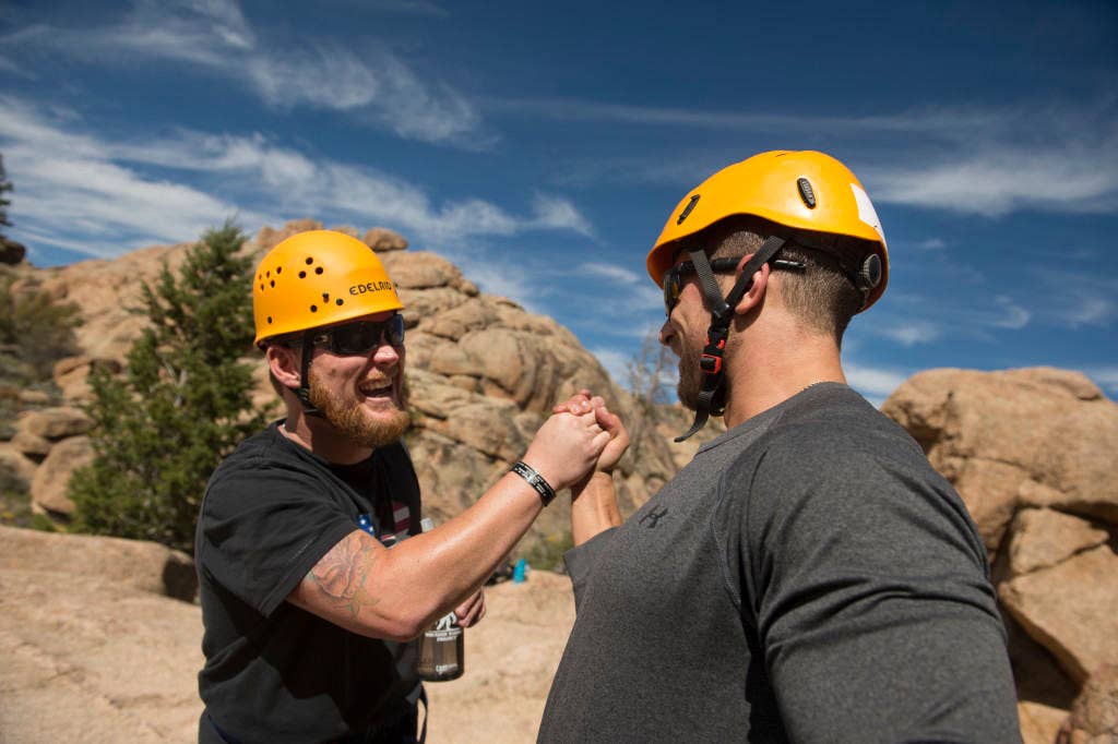 U.S. Air Force Staff Sgt. Richard W. Rose Jr. (Ret.) and Staff Sgt. Gideon Connelly celebrate after climbing a 50-foot mountain during an Adaptive Sports Camp in Crested Butte, Colorado. (U.S. Air Force photo by/Staff Sgt. Vernon Young Jr.)