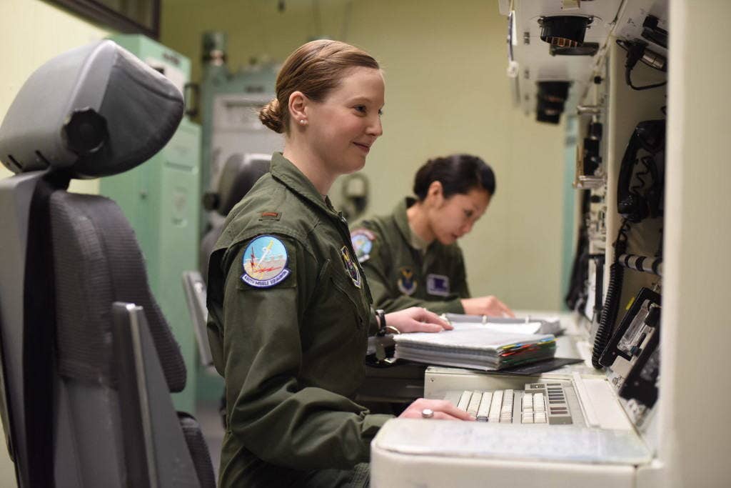 Second Lt. Alexandra Rea, 490th Missile Squadron ICBM combat crew deputy director, left, and 1st Lt. Elizabeth Guidara, 12th Missile Squadron combat crew deputy director, perform training at the Malmstrom Air Force Base, Mont. Building 500 Missile Procedures Trainer March, 21, 2016. (U.S. Air Force photo by Airman Collin Schmidt)