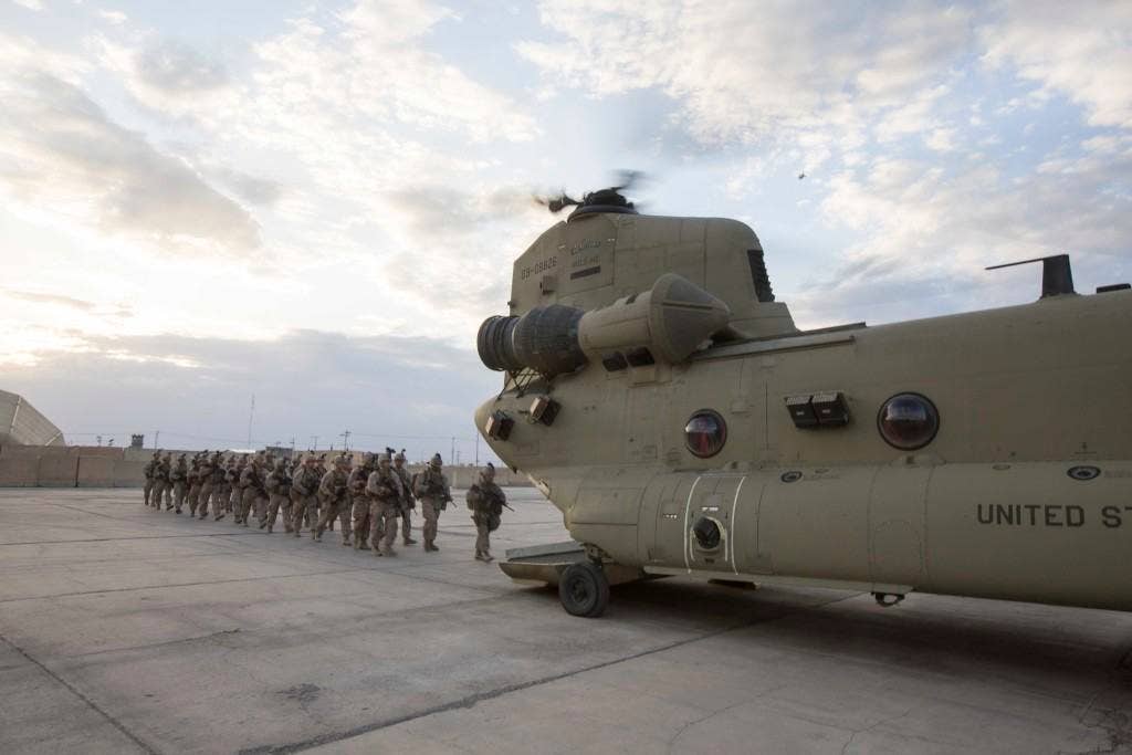 U.S. Marines with Task Force Spartan, 26th Marine Expeditionary Unit (MEU), board a CH-47 Chinook helicopter in Taji, Iraq, before heading to Kara Soar for their mission in support of Operation Inherent Resolve on March 17, 2016. Operation Inherent Resolve is an international U.S. led coalition military operation created as part of a comprehensive strategy to degrade and defeat the Islamic State of Iraq and the Levant. (U.S. Marine Corps photo by Cpl. Andre Dakis/Released)