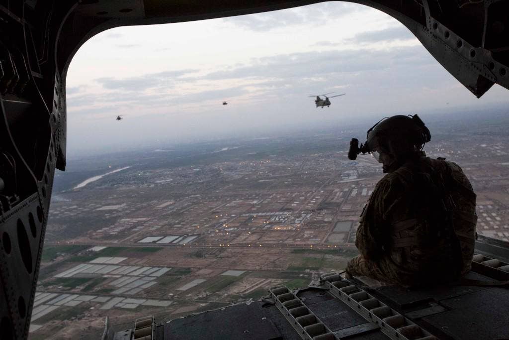 U.S. Army AH-64D Apache Longbow helicopters escort two CH-47 Chinook helicopters carrying U.S. Marines with Task Force Spartan, 26th Marine Expeditionary Unit (MEU), over Taji, Iraq, as they head to Kara Soar for their mission in support of Operation Inherent Resolve on March 17, 2016. Operation Inherent Resolve is an international U.S. led coalition military operation created as part of a comprehensive strategy to degrade and defeat the Islamic State of Iraq and the Levant. (U.S. Marine Corps photo by Cpl. Andre Dakis/Released)