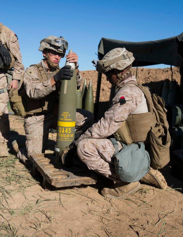 U.S. Marine Corps Cpl. Jordan Crupper, an artilleryman, and Sgt. Onesimos Utey, an artillery section chief, both with Task Force Spartan, 26th Marine Expeditionary Unit (MEU), prepare an Excalibur 155 mm round on Fire Base Bell, Iraq, while conducting fire missions against an Islamic State of Iraq and the Levant (ISIL) infiltration route March 18, 2016. Operation Inherent Resolve is an international U.S. led coalition military operation created as part of a comprehensive strategy to degrade and defeat ISIL. (U.S. Marine Corps photo by Cpl. Andre Dakis/Released)