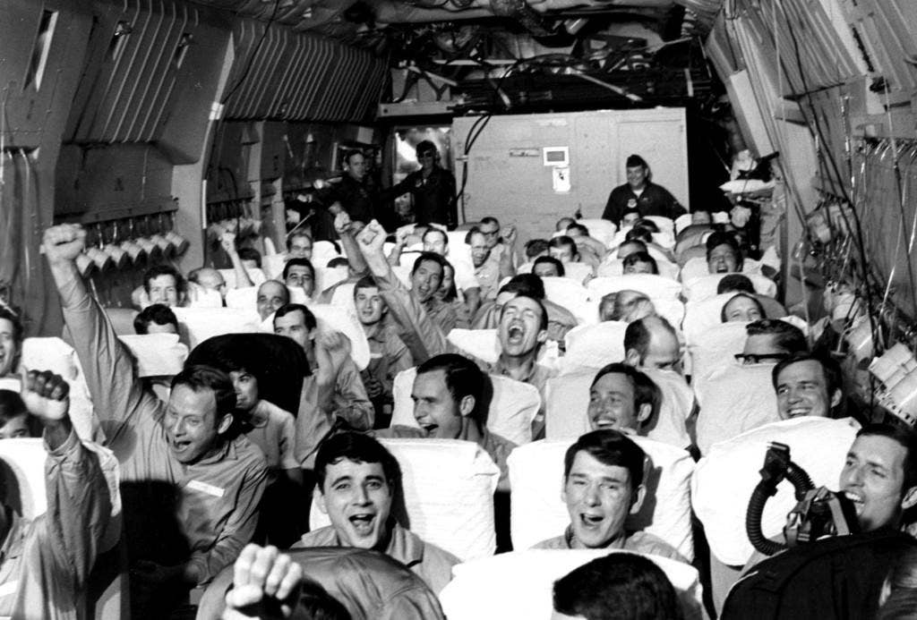 Newly freed prisoners of war celebrate as their C-141A aircraft lifts off from Hanoi, North Vietnam, on Feb. 12, 1973, during Operation Homecoming. The mission included 54 C-141 flights between Feb. 12 and April 4, 1973, returning 591 POWs to American soil. (U.S. Air Force photo)