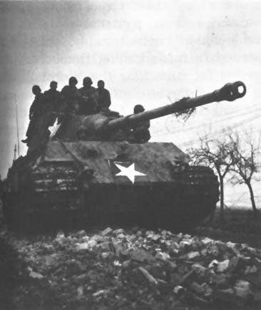 American troops ride a captured German tank during the Battle of Hurtgen Forest. The Allied advance in 1945 ended the German counterfeiting operation and resulted in the liberation of the printers. (Photo: U.S. Army)