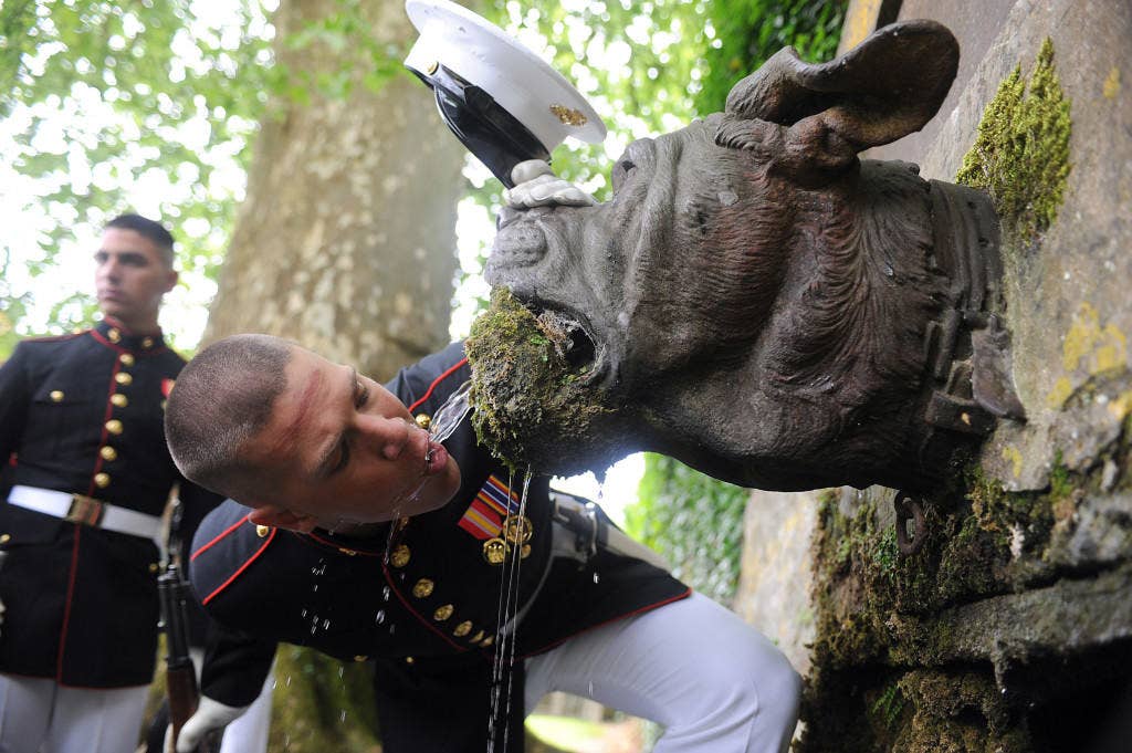 Lance Cpl. Seth H. Capps, a member of the United States Marine Corps Silent Drill Platoon, drinks out of Devil Dog Fountain following the 93rd anniversary of the Battle for Belleau Wood May 30. (Photo By Cpl. Bobby J. Yarbrough)