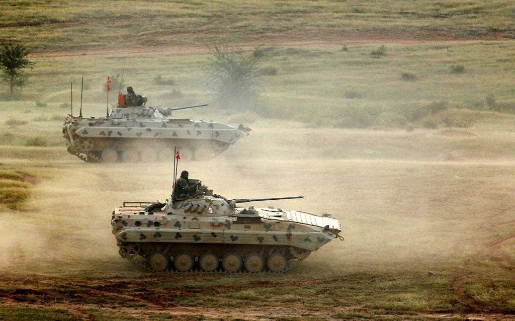 Indian army infantry vehicles move onto the firing range at Camp Bundela, India Oct. 26, 2009.