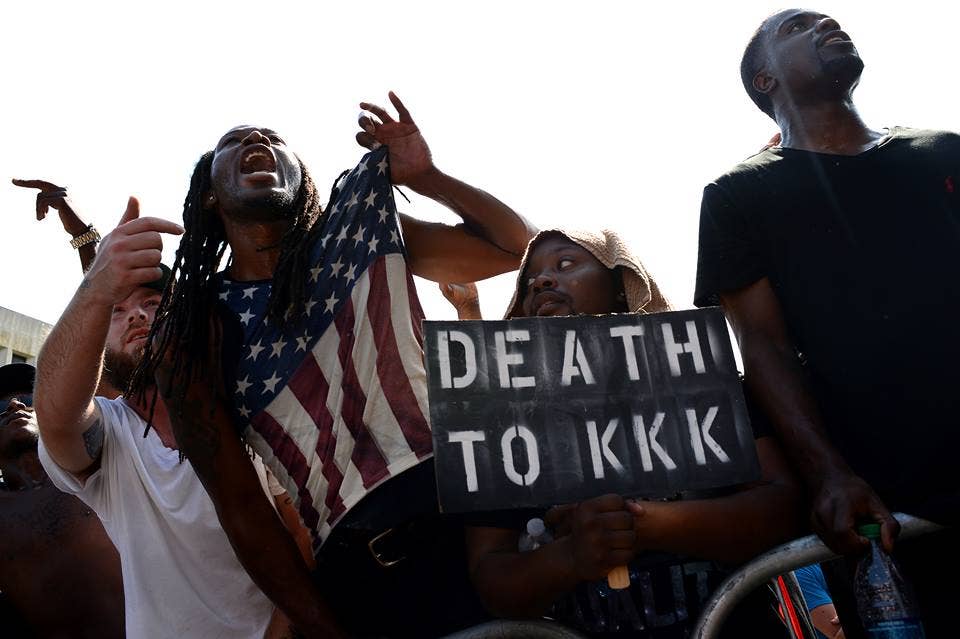 Dueling demonstrations clash as the Klu Klux Klan holds a protest rally on the steps of the S.C. State House building at the same time as a New Black Panther Party rally coupled with other black activist groups, July19, 2015, Columbia, S.C. The KKK held the rally to protest against the removal of the Confederate Flag from the State House grounds which was taken down July 10, 2015. The demonstration groups nearly went head-to-head as both rallies concluded and ended up face-to-face in the streets of downtown Columbia. In this photo young African American men push past medal barricades which are the only thing between them and several KKK members as they shout at the Klan members to leave or die. (U.S. Air Force photo by Staff Sgt. Kenny Holston)