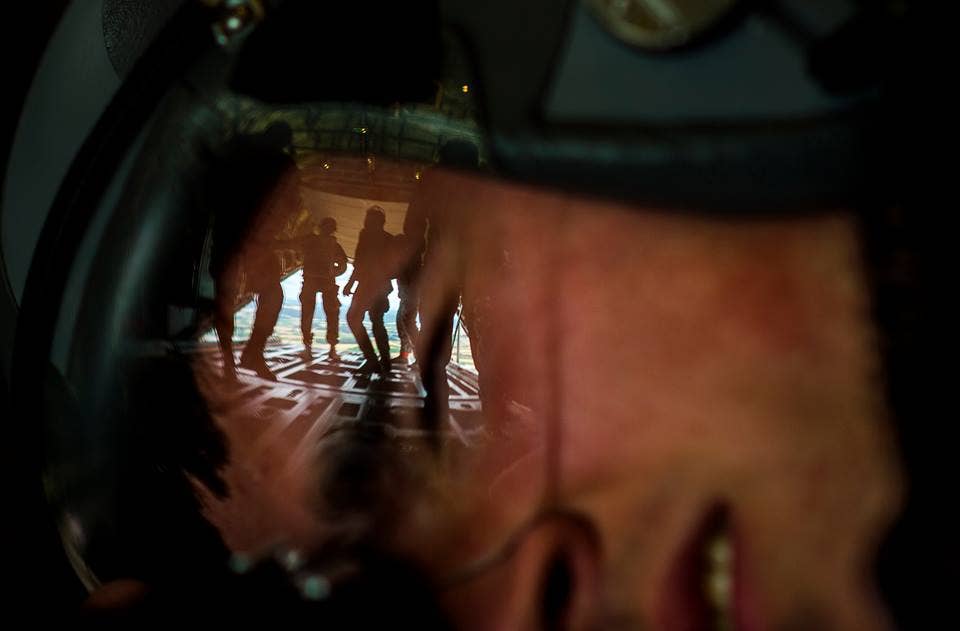 Airman 1st Class Lane Plummer, 86th Airlift Wing Public Affairs photojournalist, photographs paratroopers from multiple allied nations as they exit a C-130J Super Hercules during International Jump Week, July 9, 2015 at Ramstein Air Base, Germany. The five-day event was led by the 435th Contingency Response Group and provided multiple nations the opportunity to work side-by-side, increasing interoperability and strengthening relationships. Paratroopers traveled from throughout Europe and as far away as New Zealand to build stronger partnerships by jumping out of aircraft assigned to the 37th Airlift Squadron at Ramstein. (U.S. Air Force photo taken by Senior Airman Damon Kasberg)