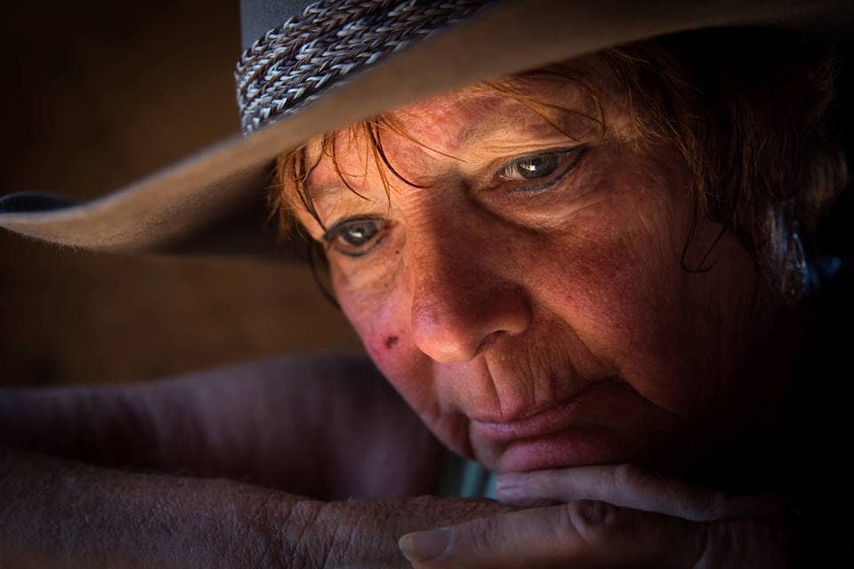 Susan Peterson rests on her horse barn's door in Norco, Calif., June 18, 2015. Peterson spent the morning playing with her horses and mule. The photo was taken during the 2015 Department of Defense Photography workshop held in Riverside, Calif. The workshop brought photographers and videographers from across the DOD together, while industry and military leaders mentored and developed them for a week. (U.S. Army photo by Staff Sgt. Marcus Fichtl)