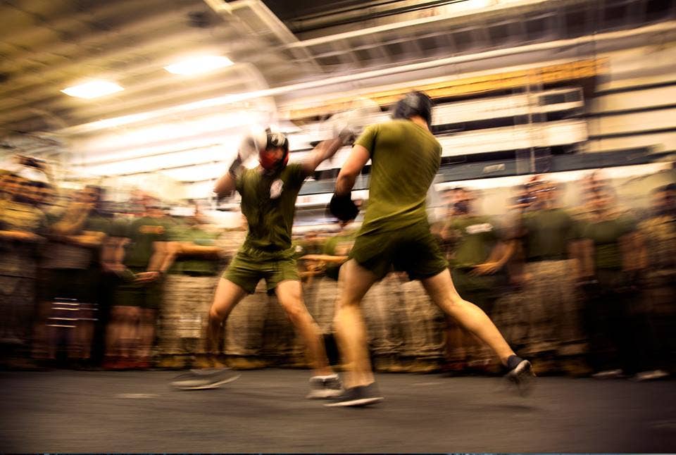 U.S. Marine Cpl. Roman Fernandez, left, and 1st Lt. Paul Hollwedel duke it out in the hangar bay of the USS Essex (LHD 2) at sea in the Pacific Ocean, May 29, 2015. Fernandez is a team leader and Hollwedel is the executive officer with Lima Company, Battalion Landing Team 3rd Battalion, 1st Marine Regiment, 15th Marine Expeditionary Unit. The Marines found unique ways to continue to maintain combat readiness during their seven-month deployment through the Pacific and Central Command areas. U.S. Marine Corps photo by Cpl. Elize McKelvey)