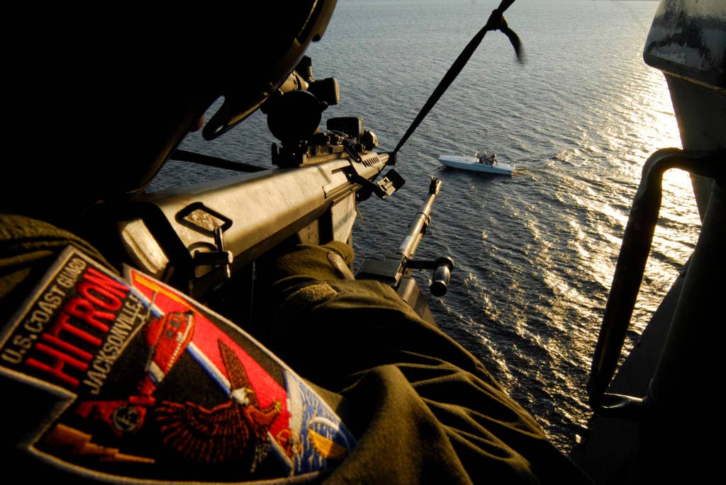 JACKSONVILLE, Fla. - Petty Officer 2nd Class (AMT2) Lee Fenton of Helicopter Interdiction Tactical Squadron takes aim with a decommissioned .50 caliber precision rifle during training in the St. Johns River, Fla., March 26, 2008. Lee is one of several gunners getting qualified on the new MH-65C dolphin helicopter. HITRON started receiving the new helicopter in September 2007. Some additional features on the new helicopter include a forward-looking infrared device and heads-up-display to enhance night operations, and an electro-optical sensor system to enhance detection capabilities. Coast Guard photograph by PA2 Bobby Nash.