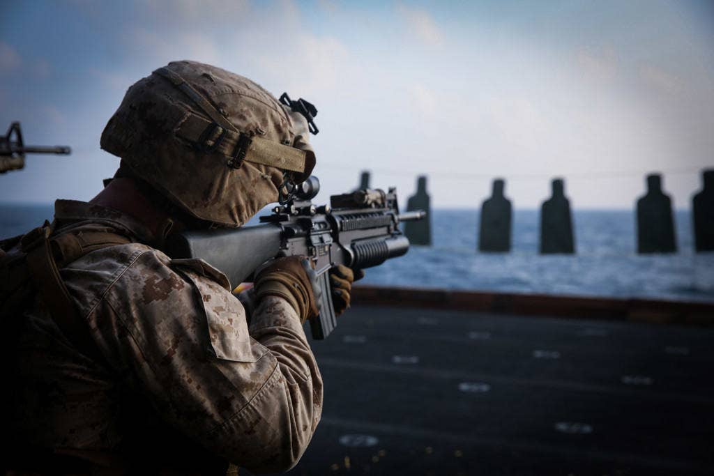 A U.S. Marine with Fox Company, Battalion Landing Team 2nd Battalion, 1st Marines, 11th Marine Expeditionary Unit (MEU), fires his weapon as part of a deck shoot aboard the amphibious assault ship USS Makin Island (LHD 8). (U.S. Marine Corps photo by Cpl. Evan R. White)