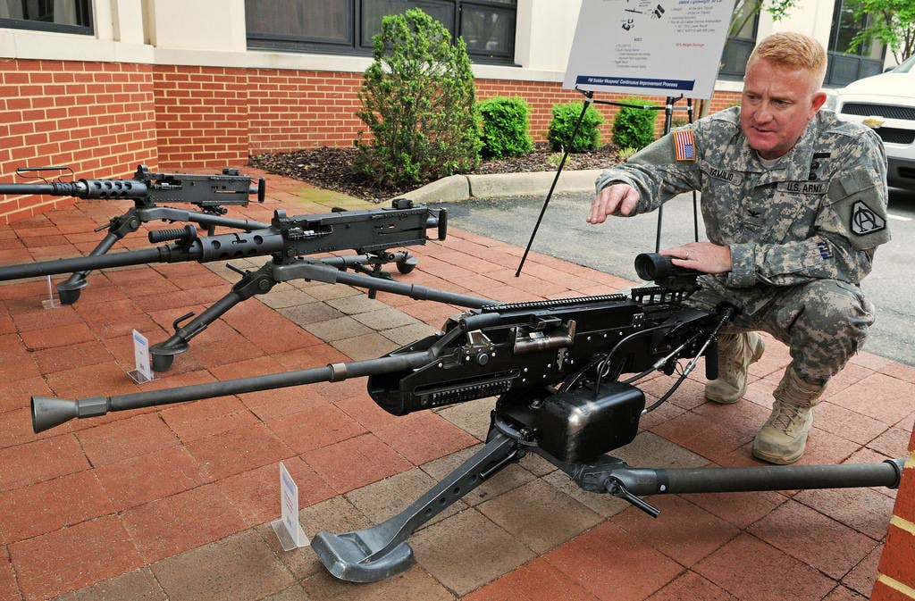 Col. Doug Tamilio, program manager for Soldier weapons and Soldier lethality and weight reduction, point out features of the Lightweight .50-Caliber Machine Gun. | US Army photo