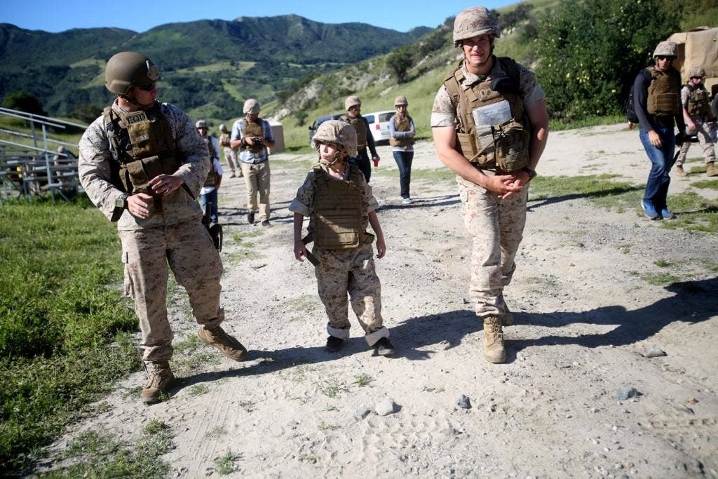 Nathan Aldaco, a 12 year-old boy with hypoplastic left heart syndrome, walks with Marines to a demolition site during a Make-A-Wish event supported by 7th Engineer Support Battalion, 1st Marine Logistics Group, aboard Camp Pendleton, Calif. (U.S. Marine Corps photo by Sgt. Laura Gauna)