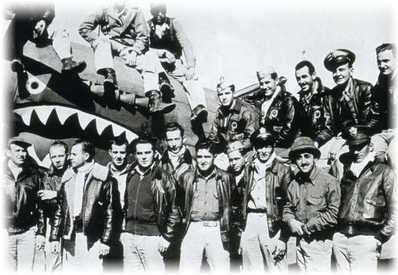 The Flying Tigers personnel pose around one of their airplanes. (Photo: U.S. Army Air Corps)