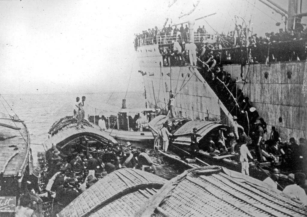 An undated photo show American troops disembarking from a ship onto small boats near Cavite, Phillipines in 1898 or 1899. The photo archives staff found a wooden box containing approximately 150 glass plate photographs depicting scenes from the Spanish-American and Philippine Wars. The glass plate photographs were likely prepared by photographer Douglas White, a war correspondent for the San Francisco Examiner during the Philippine War. (U.S. Navy photo courtesy of Naval History and Heritage Command)