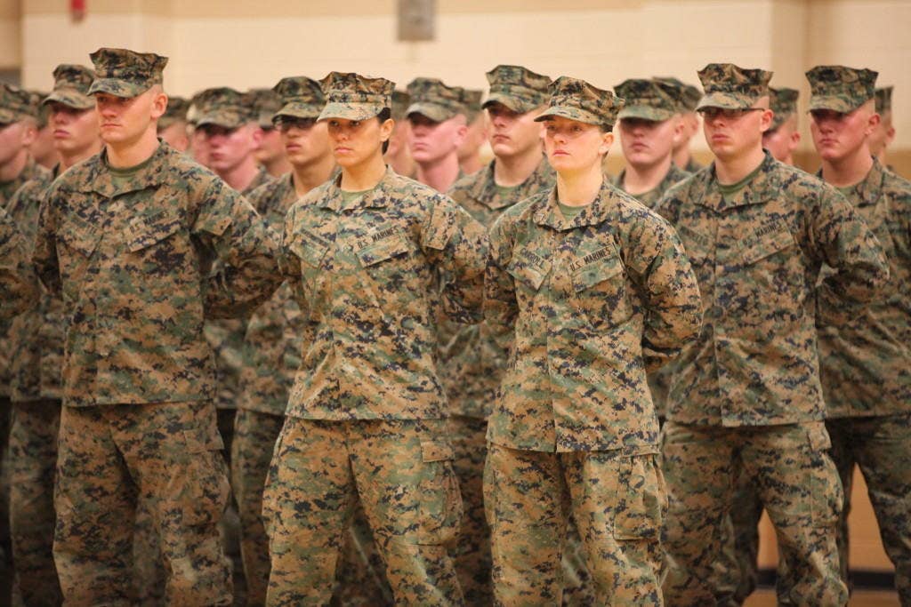 U.S. Marines PFC. Cristina Fuentes Montenegro (center left) and PFC. Julia R. Carroll (center right) of Delta Company, Infantry Training Battalion, School of Infantry - East (SOI-E), stand at parade rest during their graduation ceremony from SOI-E aboard Camp Geiger, N.C. (U. S. Marine Corps photo by LCpl. Nicholas J. Trager)