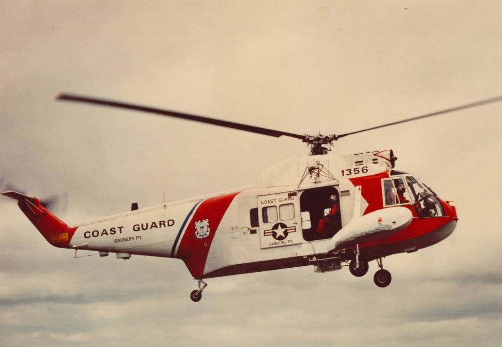 coast guard rescue swimmer in helicopter