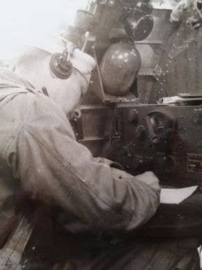Rector at his radio operator console aboard at B-17 during a bombing raid. (Photo: Rector family archives)